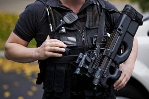 A Secret Service agent with the Counter Assault and Tactical Division holds a loaded weapon in front of the North Portico of the White House in Washington.